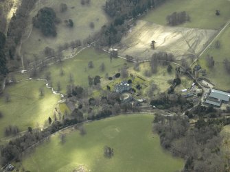 General oblique aerial view centred on the country house, gardens and stable with the walled garden and farmsteading adjacent, taken from the NNW.