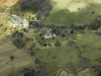 General oblique aerial view centred on the country house, gardens and stable with the walled garden and farmsteading adjacent, taken from the SE.