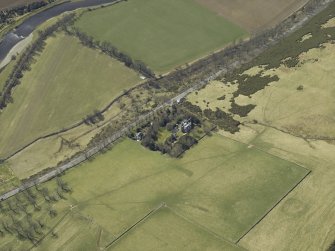 Oblique aerial view centred on the country house and landscaped garden, taken from the NE.