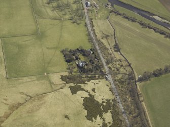Oblique aerial view centred on the country house and landscaped garden, taken from the WNW.