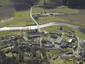 Oblique aerial view centred on the woollen mill with the road bridge and convent  adjacent, taken from the N.