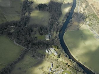 Oblique aerial view centred on the country house with the farmsteading, farmhouse and lodge adjacent, taken from the SE.