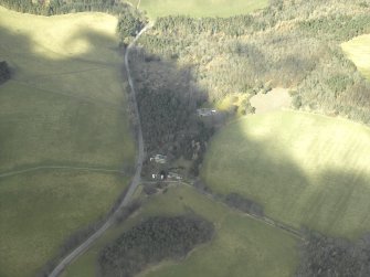 Oblique aerial view centred on the textile design studio and the house, taken from the SE.