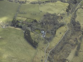Oblique aerial view centred on country house, taken from the NW.