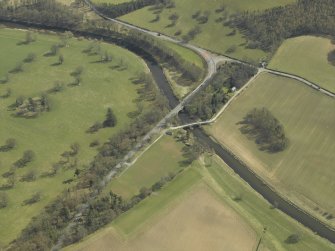 Oblique aerial view centred on the road bridges, taken from the NW.
