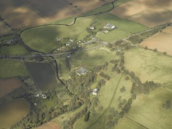 General oblique aerial view centred on the country house and stables with the gate-lodges, walled garden and village adjacent, taken from the SSE.