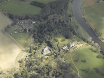 General oblique aerial view centred on the country house, stables and gardens with the house adjacent, taken from the W.