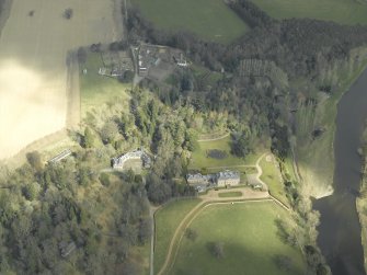 General oblique aerial view centred on the country house, stables and gardens with the house adjacent, taken from the SW.