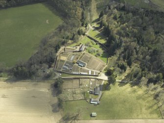 Oblique aerial view centred on the house, taken from the NW.