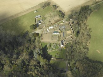 Oblique aerial view centred on the house, taken from the SSE.