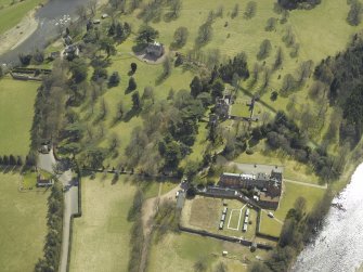 Oblique aerial view centred on the remains of the abbey with the hotel and country house adjacent, taken from the N.