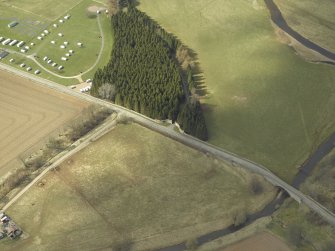 Oblique aerial view centred on the gates with the caravan site and road bridge adjacent, taken from the ESE.