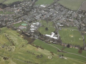 General oblique aerial view centred on the school and swimming pool, taken from the WNW.