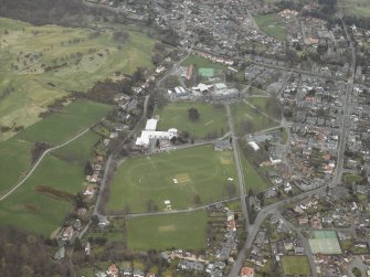 General oblique aerial view centred on the school and swimming pool, taken from the WSW.