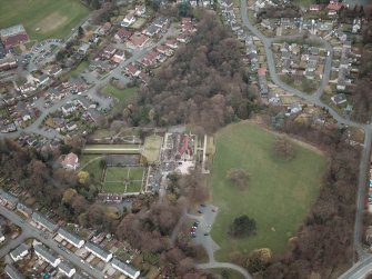 Oblique aerial view centred on the house and walled garden, taken from the NE.