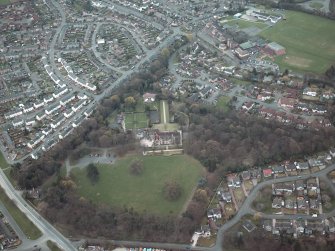Oblique aerial view centred on the house and walled garden with the gate lodge adjacent, taken from the NW.
