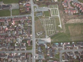 Oblique aerial view centred on the churches, burial-ground and church hall, taken from the S.