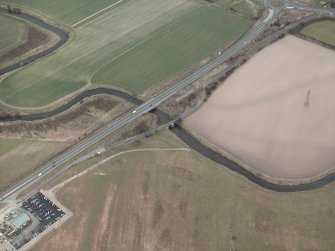Oblique aerial view centred on the road bridges, taken from the SW.