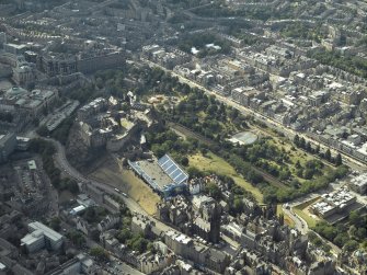 General oblique aerial view centred on the garden, bandstand, art galleries, churches and castle, taken from the SE.