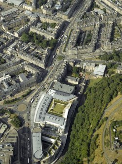 Oblique aerial view centred on the hotel, cinemas and theatre, taken from the SSW.