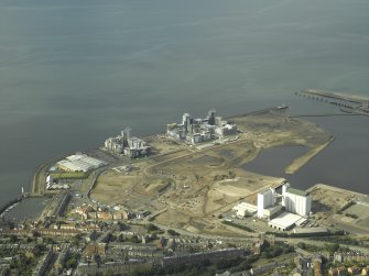 Oblique aerial view centred on the construction of the flats with the shipbuilding yard in the foreground, taken from the S.