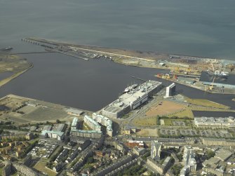 Oblique aerial view centred on the shopping centre, cinema, restaurants, visitor centre, shed and harbour, taken from the S.