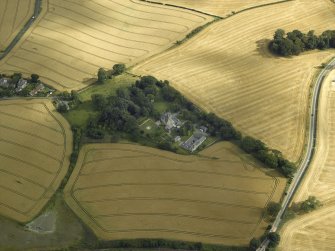 Oblique aerial view centred on the Laird's house, dovecot and walled garden, taken from the NW.