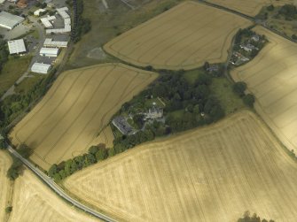 Oblique aerial view centred on the Laird's house, dovecot and walled garden, taken from the SW.