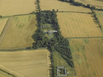 Oblique aerial view centred on the country house, greenhouse, walled garden, granary and farmsteading, taken from the NNW.