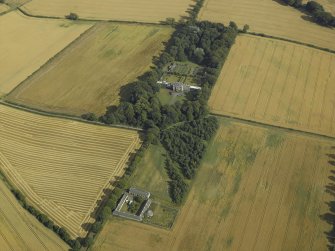 Oblique aerial view centred on the country house, greenhouse, walled garden, granary and farmsteading, taken from the NW.