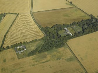 Oblique aerial view centred on the country house, greenhouse, walled garden, granary and farmsteading, taken from the W.