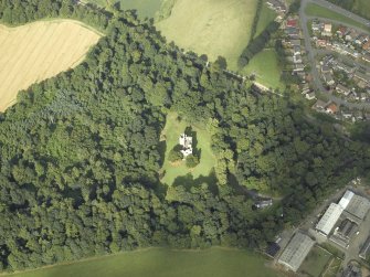 Oblique aerial view centred on the remains of the castle with the railway adjacent, taken from the WSW.