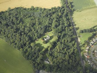 Oblique aerial view centred on the remains of the castle with the railway adjacent, taken from the SSW.