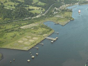 General oblique aerial view centred on the remains of the shipyard with the castle adjacent, taken from the WSW.