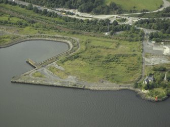 Oblique aerial view of the remains of the shipyard with the dock and castle adjacent, taken from the S.