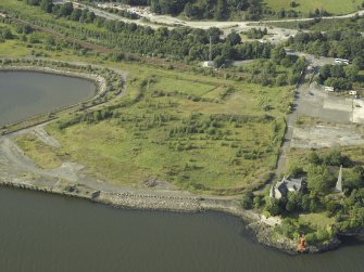Oblique aerial view of the remains of the shipyard with the castle adjacent, taken from the SSE.