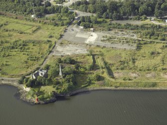 Oblique aerial view of the remains of the shipyard with the castle adjacent, taken from the S.