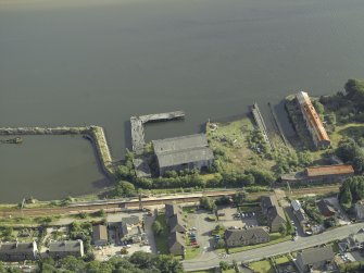 Oblique aerial view of the harbour and the remains of the shipyard, taken from the NNE.