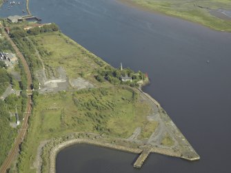 General oblique aerial view of the remains of the shipyard centred on the castle, taken from the WNW.