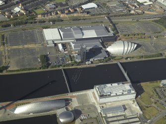 Oblique aerial view of the River Clyde centred on the bridges with the exhibition centre and science centre adjacent, taken from the SSW.