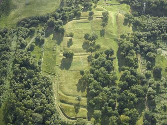 Oblique aerial view centred on the remains of the Roman fort and the course of the Antonine Wall, taken from the ENE.