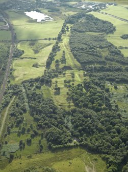 General oblique aerial view centred on the remains of the Roman fort and the course of the Antonine Wall, taken from the ENE.
