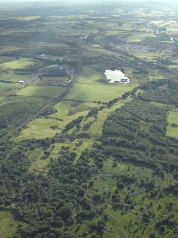 General oblique aerial view centred on the remains of the Roman fort and the course of the Antonine Wall, taken from the NE.
