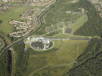 Oblique aerial view centred on the canal lift, canal basins, slipway, lock, footbridge and visitor centre, taken from the W.