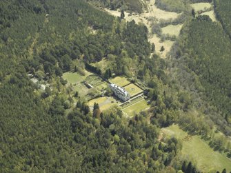 Oblique aerial view centred on the country house with the cottage and laundry adjacent, taken from the NW.