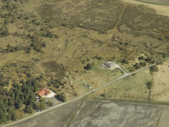 Oblique aerial view centred on the remains of the cottage, taken from the W.