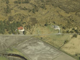 Oblique aerial view centred on the remains of the cottage, taken from the SW.