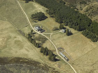 Oblique aerial view centred on the lodge with the keepers house and kennels adjacent, taken from the E.