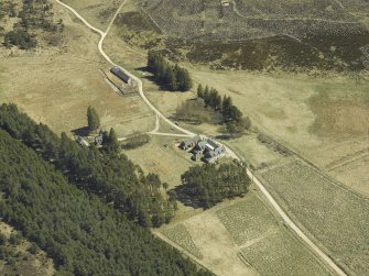 Oblique aerial view centred on the lodge with the keepers house and kennels adjacent, taken from the NW.