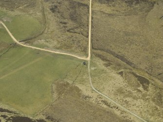 Oblique aerial view centred on the remains of the limekiln, taken from the NE.
